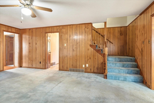 interior space featuring light carpet and ceiling fan