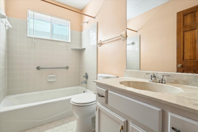 full bathroom featuring toilet, a textured ceiling, vanity, tiled shower / bath combo, and tile patterned flooring