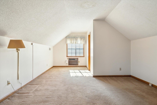 bonus room with light carpet, vaulted ceiling, and a wall unit AC