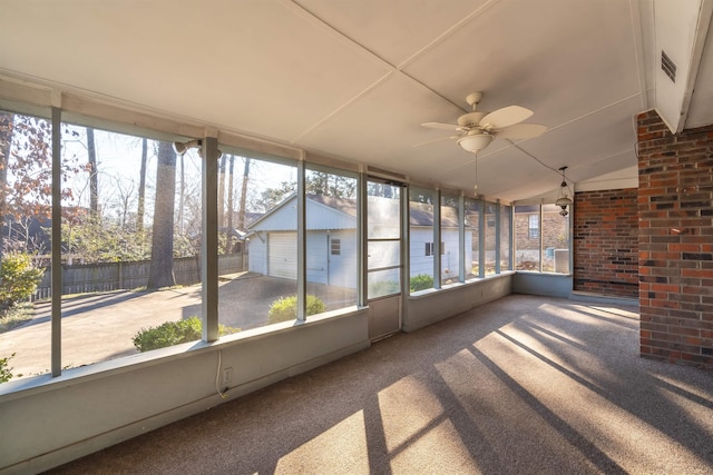 unfurnished sunroom with ceiling fan and vaulted ceiling