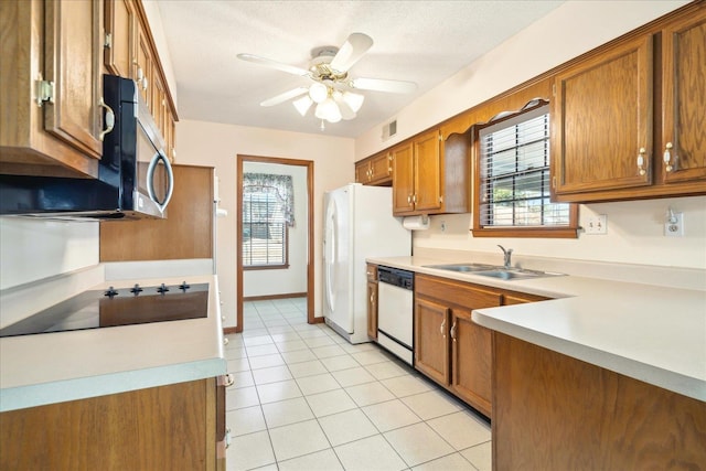 kitchen with sink, light tile patterned floors, white appliances, ceiling fan, and a textured ceiling