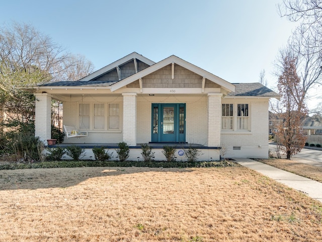 view of front of home featuring covered porch and a front yard