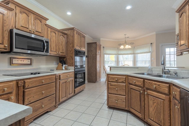 kitchen featuring sink, crown molding, light tile patterned floors, hanging light fixtures, and black appliances