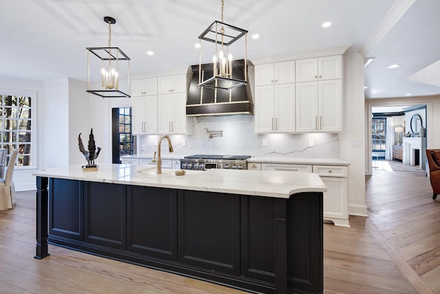 kitchen with white cabinetry, stove, and a large island