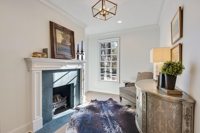 living area with an inviting chandelier, crown molding, light hardwood / wood-style flooring, and a tile fireplace