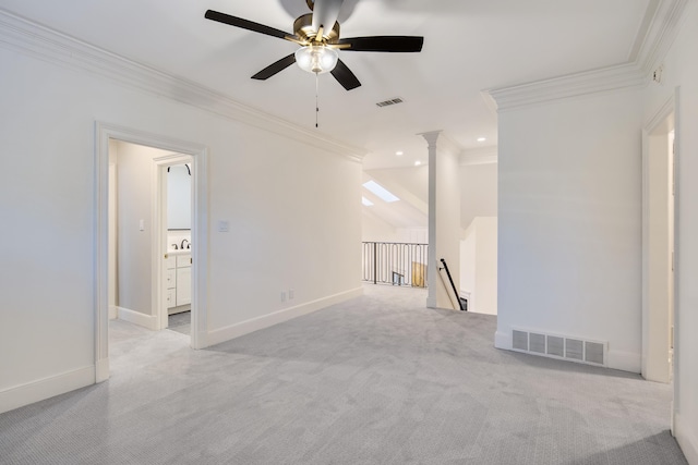 empty room featuring ceiling fan, ornamental molding, vaulted ceiling, and light carpet