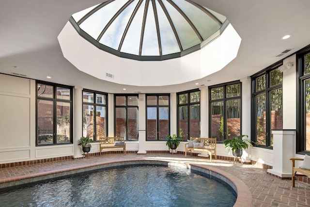 view of pool with a jacuzzi and a skylight