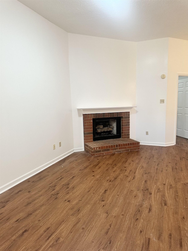 unfurnished living room featuring hardwood / wood-style floors and a fireplace