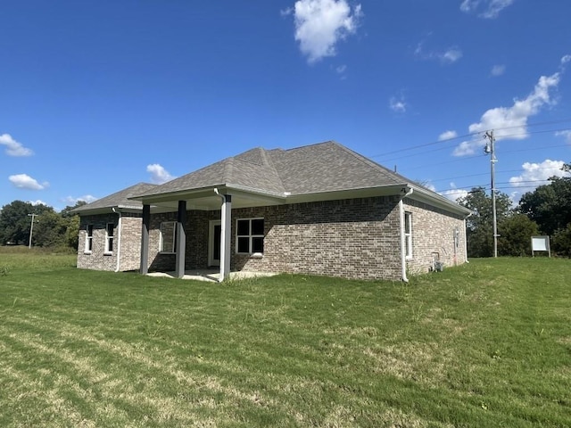 back of property featuring a lawn