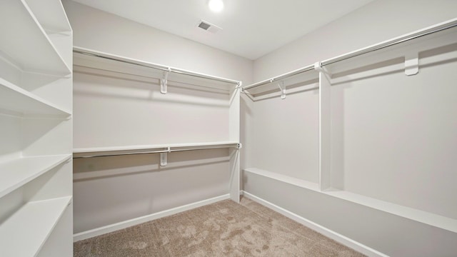 walk in closet featuring carpet flooring and visible vents