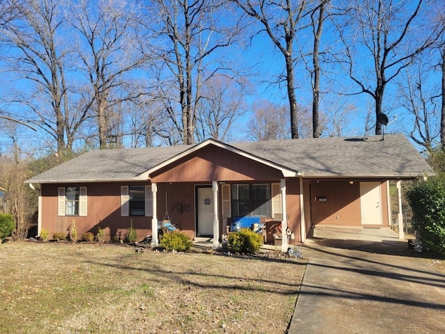 view of front facade with a carport, covered porch, and a front yard