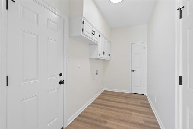 laundry area with washer hookup, hookup for an electric dryer, cabinets, and light wood-type flooring