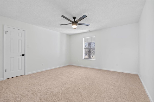 unfurnished room featuring light carpet, ceiling fan, and a textured ceiling