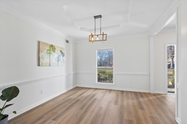 unfurnished room featuring ornamental molding, a chandelier, and light wood-type flooring