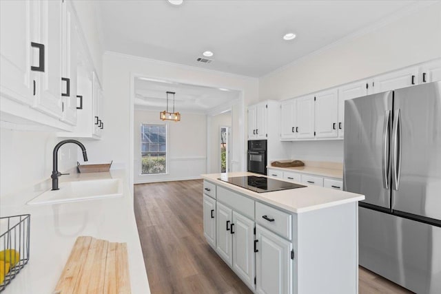 kitchen with white cabinetry, a kitchen island, sink, and black appliances