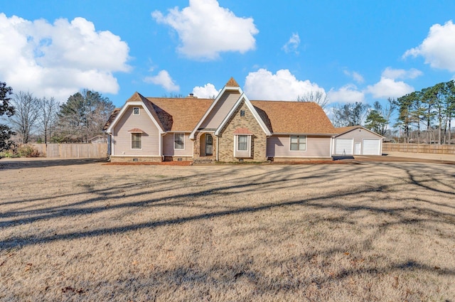 view of front of property featuring a garage and a front lawn