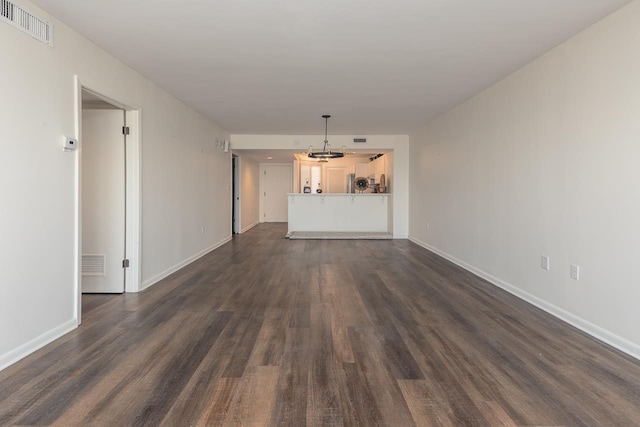 unfurnished living room featuring dark hardwood / wood-style floors