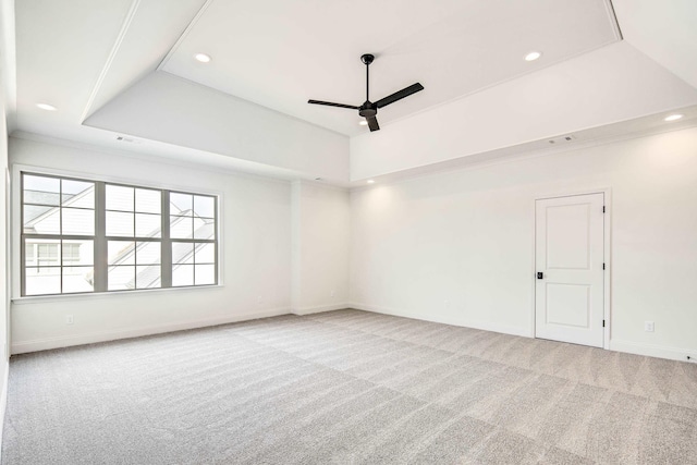 carpeted empty room featuring a tray ceiling, ceiling fan, and recessed lighting