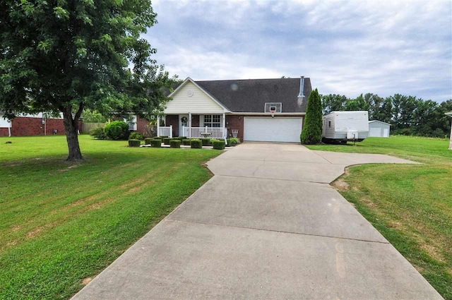 view of front of home featuring a porch, a garage, and a front lawn