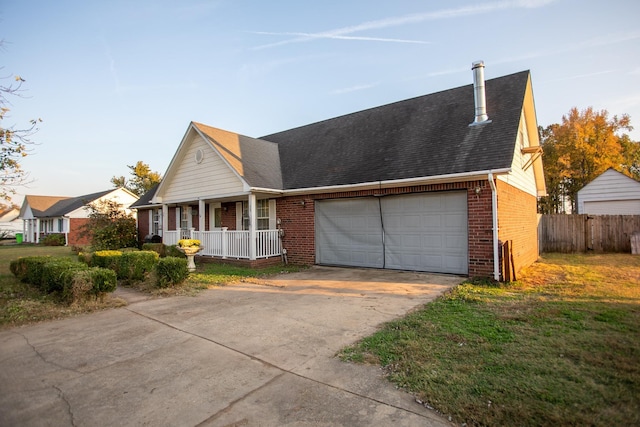 view of front of house with a porch, a garage, and a front yard