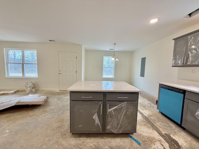 kitchen featuring light countertops, dishwasher, decorative light fixtures, and baseboards