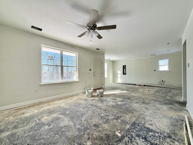 unfurnished living room featuring ceiling fan and baseboards