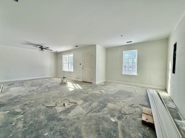 unfurnished room featuring visible vents, baseboards, and a ceiling fan