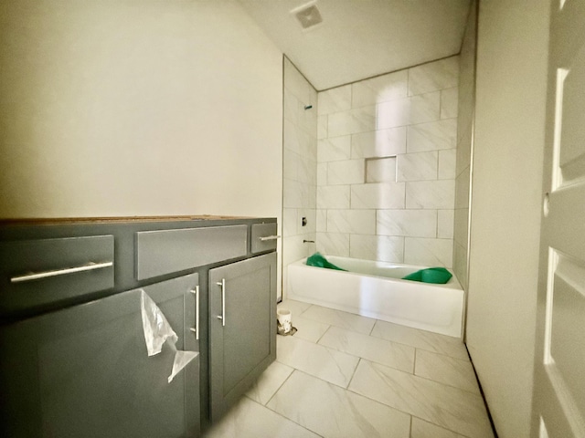 full bath featuring  shower combination and marble finish floor