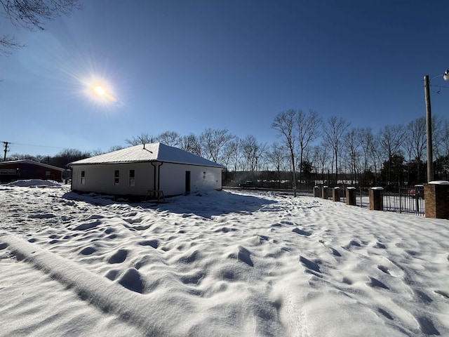 snowy yard featuring fence