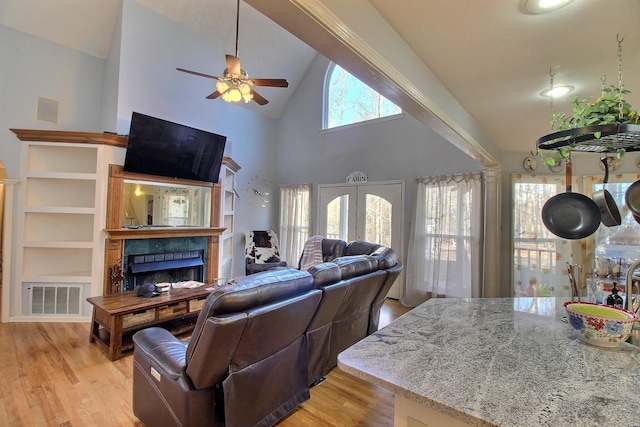 living room featuring french doors, ceiling fan, high vaulted ceiling, and light hardwood / wood-style floors