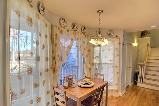 dining area with an inviting chandelier and light wood-type flooring