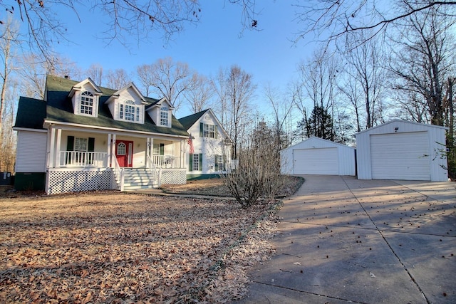 view of front of home featuring a garage, an outdoor structure, and covered porch