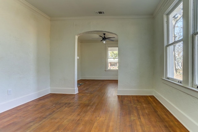 empty room with crown molding, ceiling fan, and dark hardwood / wood-style flooring