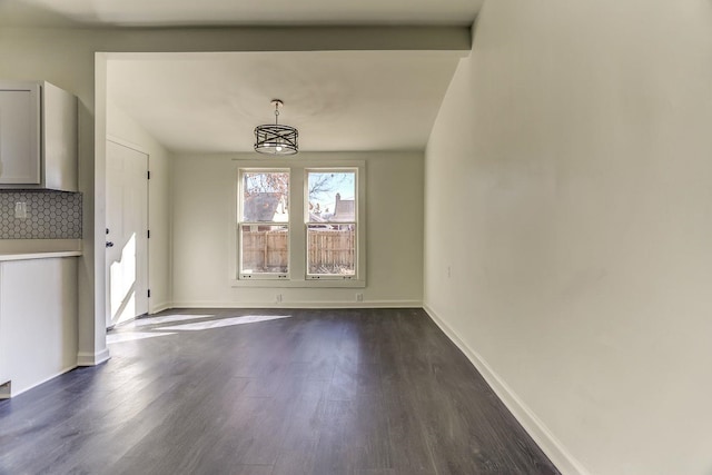 unfurnished dining area featuring dark wood-type flooring