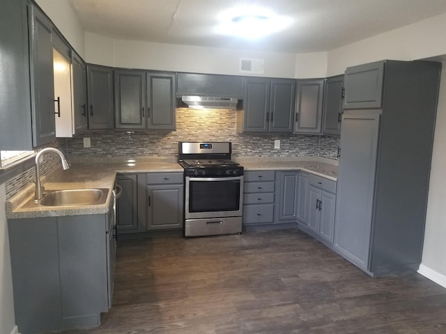 kitchen with sink, gray cabinetry, backsplash, exhaust hood, and stainless steel gas range oven