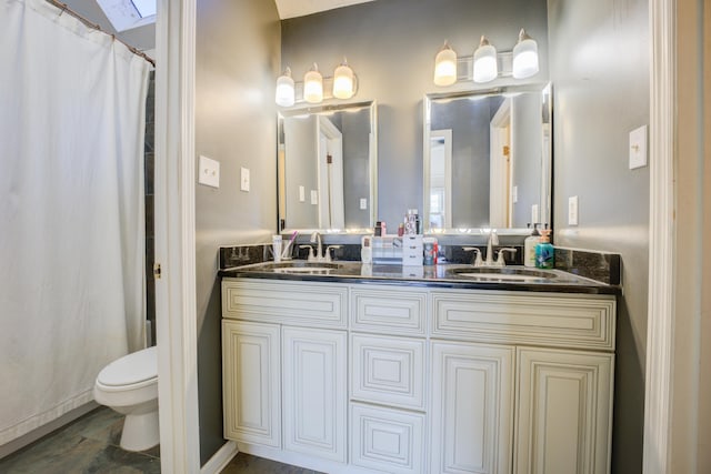 bathroom featuring vanity, toilet, and a shower with shower curtain