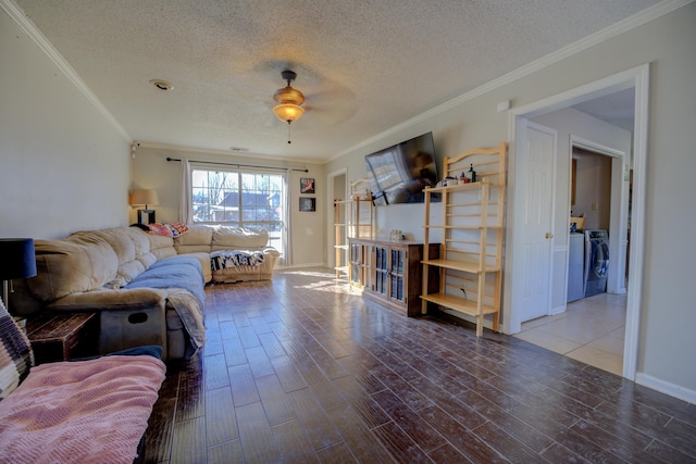 living room with separate washer and dryer, ceiling fan, crown molding, and a textured ceiling