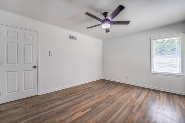 empty room with dark hardwood / wood-style floors and ceiling fan