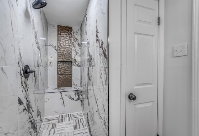 bathroom with a tile shower