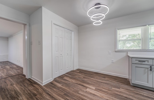 unfurnished dining area featuring dark hardwood / wood-style floors