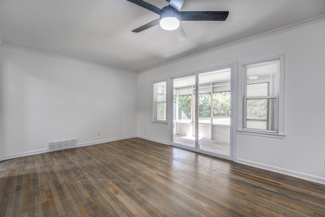 empty room featuring dark wood-type flooring, ceiling fan, and ornamental molding