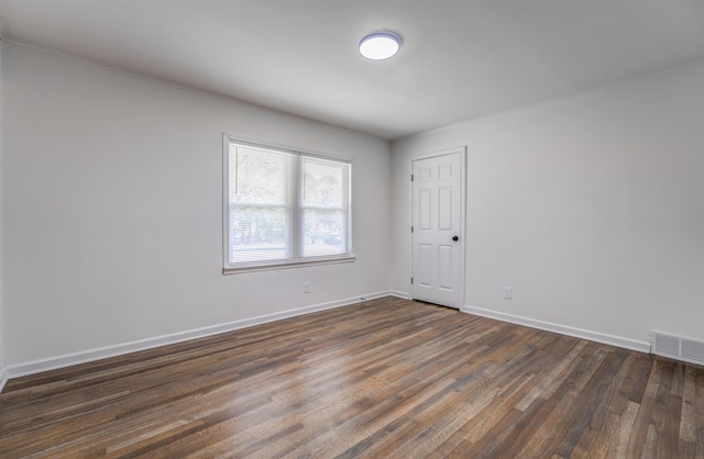 spare room with dark hardwood / wood-style floors