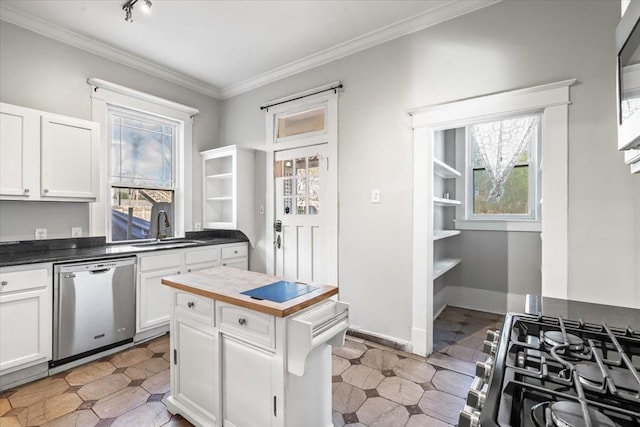 kitchen featuring sink, crown molding, stainless steel appliances, track lighting, and white cabinets