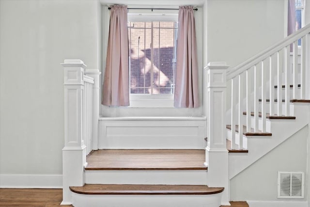 stairway featuring wood-type flooring