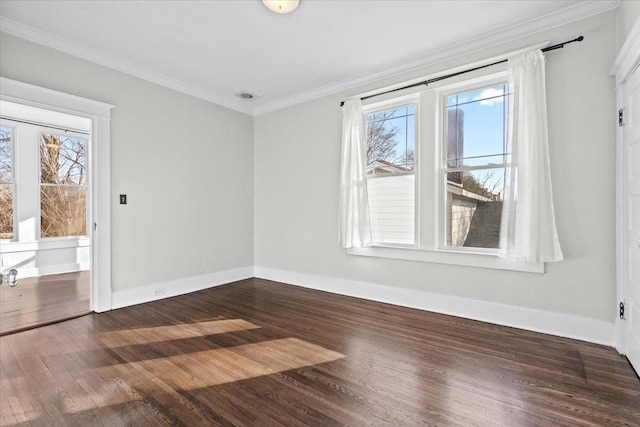 empty room featuring crown molding, a healthy amount of sunlight, and dark wood-type flooring