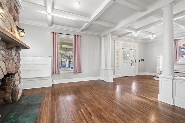 unfurnished living room featuring a stone fireplace, decorative columns, wood-type flooring, beamed ceiling, and coffered ceiling