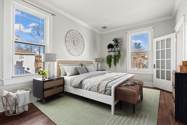 bedroom featuring crown molding and dark hardwood / wood-style flooring