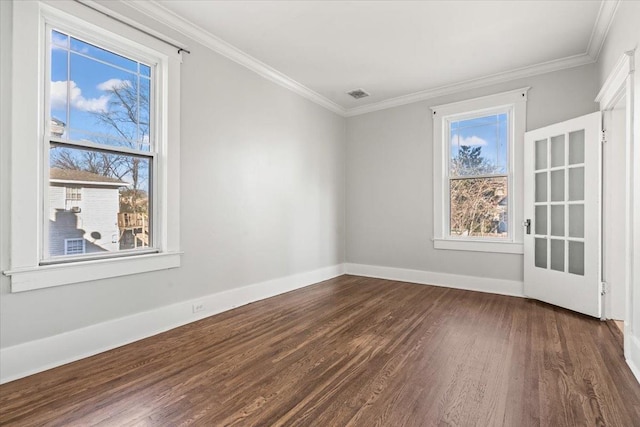 empty room with dark wood-type flooring and ornamental molding