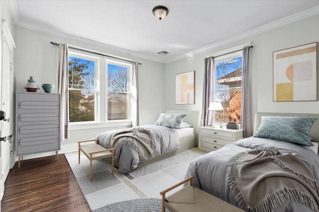 bedroom with ornamental molding and dark hardwood / wood-style floors