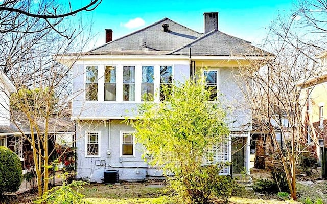 rear view of property featuring central air condition unit